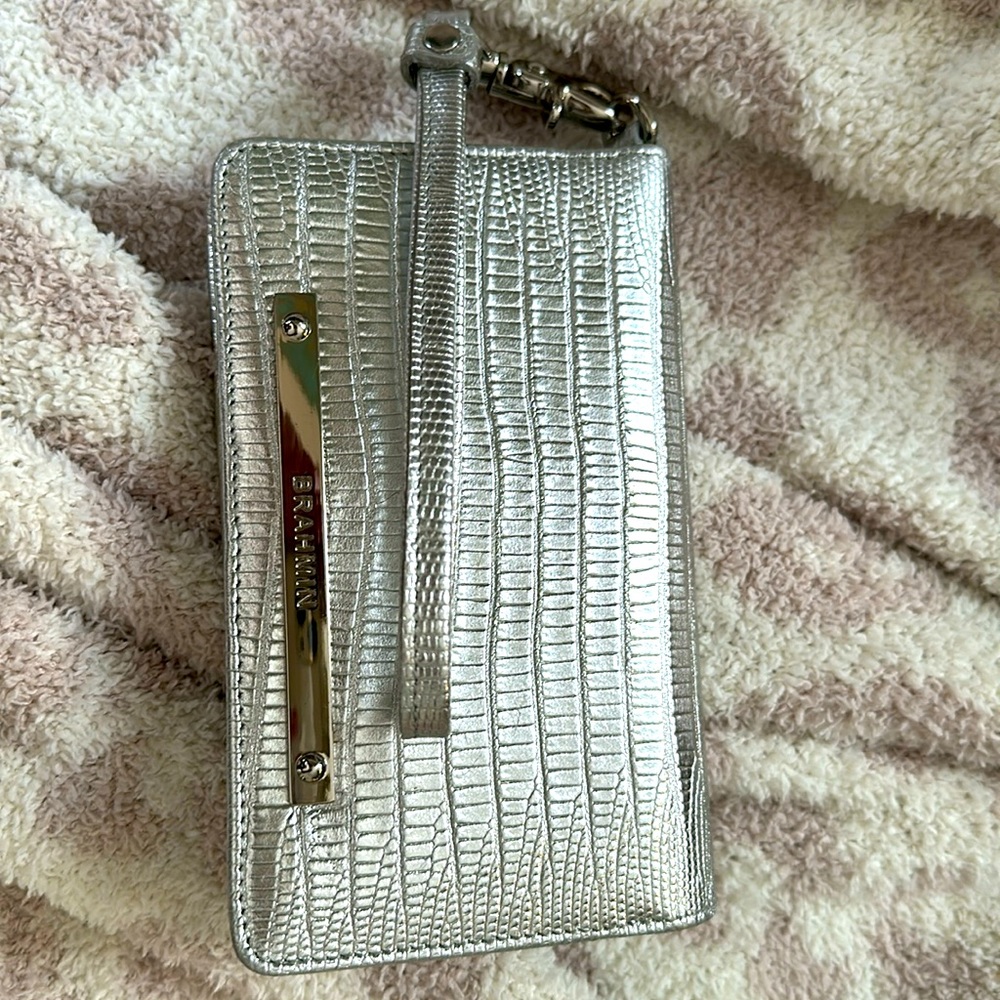 Small Brahmin silver wristlet wallet.